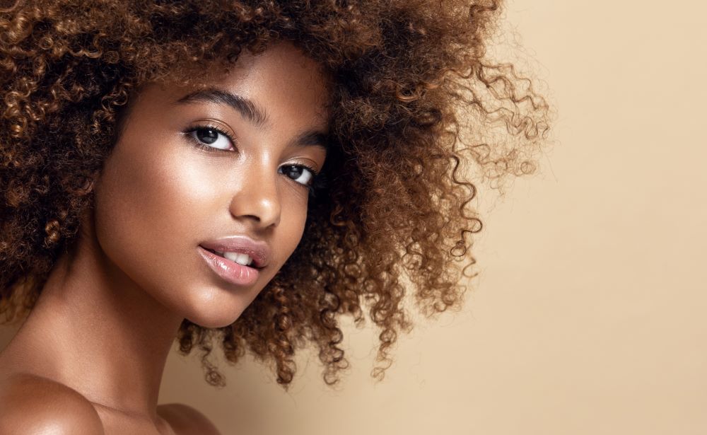 African american woman happy with her non-surgical results at Cultura.
